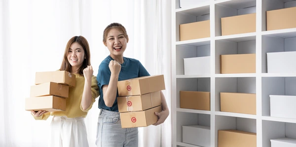 Business Colleagues Holding Paper Boxes and Raise