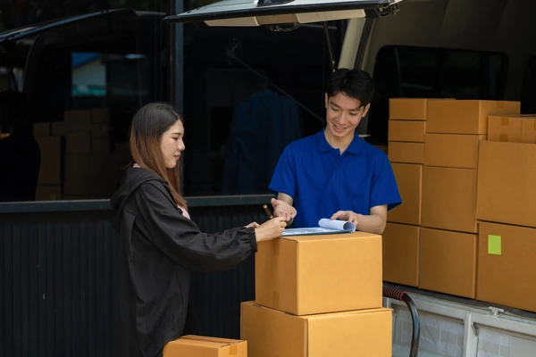 Female Customer Hand Receiving a Cardboard Boxes
