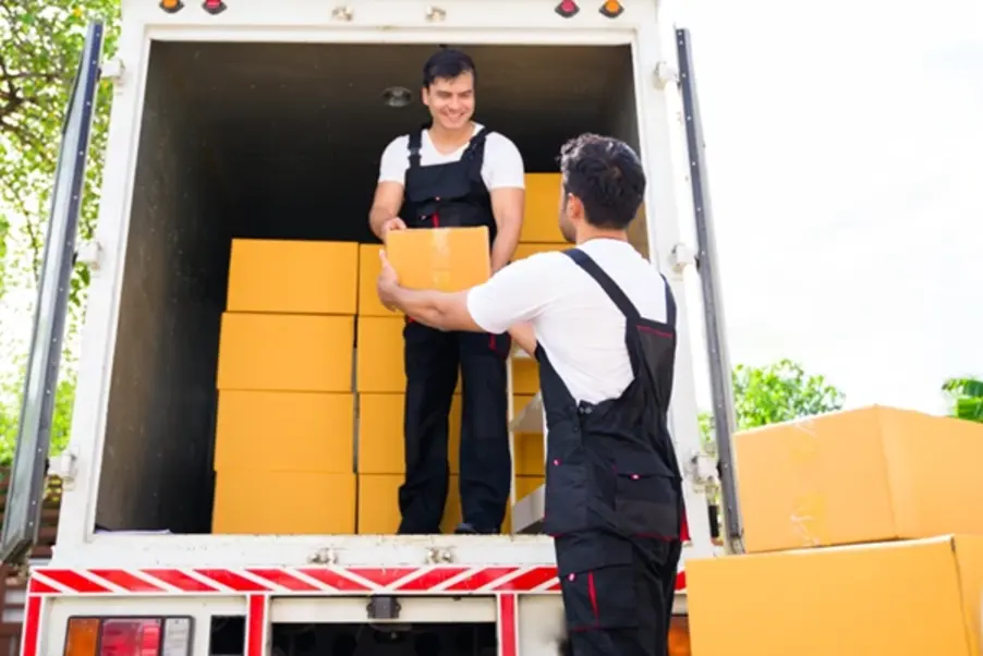 Two workers loading cargo to Malaysia
